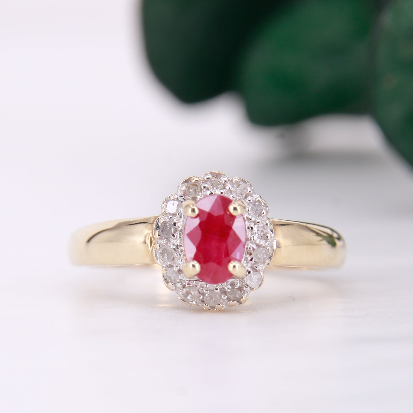 Secondhand Vintage Garnet and Ring. Halo cut Garnet with a halo of diamonds, set in 9ct gold.