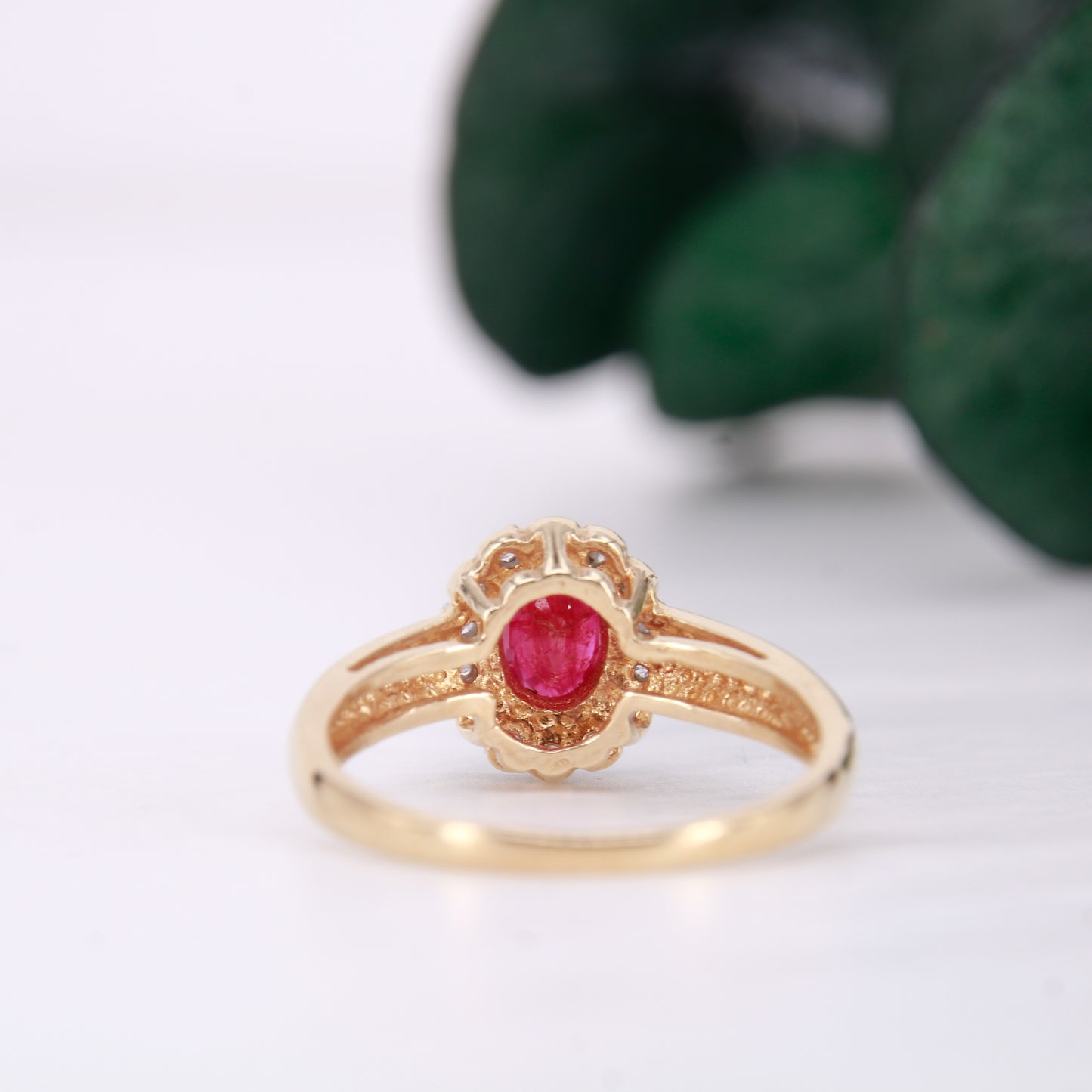 Secondhand Vintage Garnet and Ring. Halo cut Garnet with a halo of diamonds, set in 9ct gold.