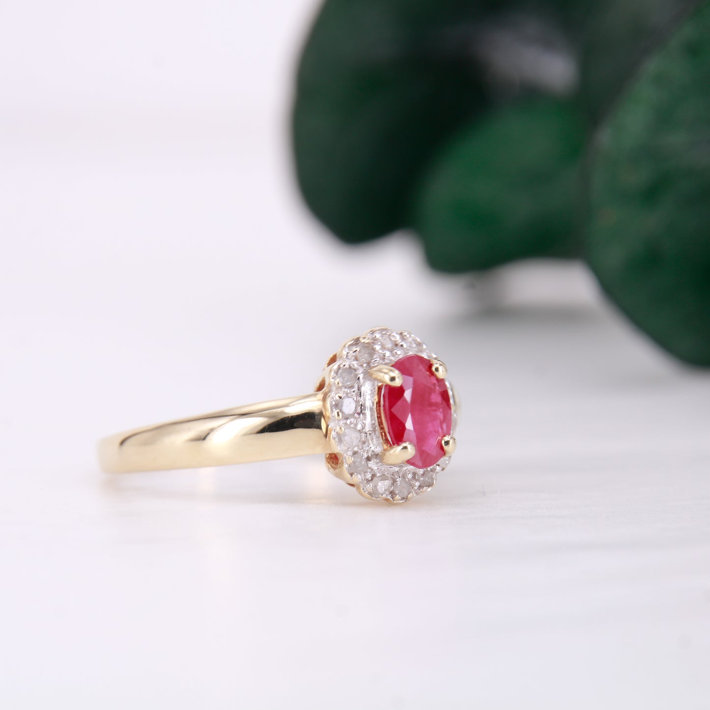 Secondhand Vintage Garnet and Ring. Halo cut Garnet with a halo of diamonds, set in 9ct gold.