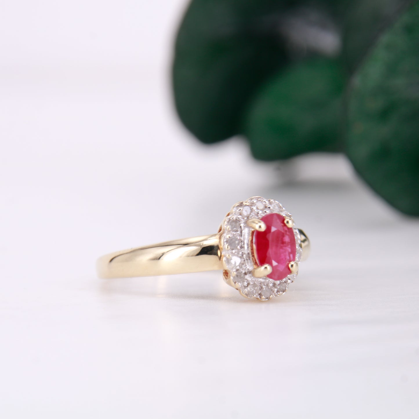 Secondhand Vintage Garnet and Ring. Halo cut Garnet with a halo of diamonds, set in 9ct gold.