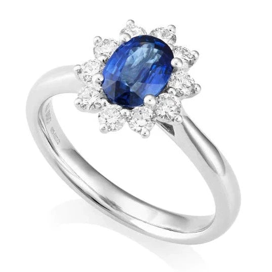 A timeless classic, an Oval Cut Sapphire and Diamond Halo. The beautiful 0.59-carat oval-cut sapphire takes centre stage, surrounded by a flower halo of 0.33 carats of diamonds. Crafted in luxurious platinum for a durable yet vintage inspired.