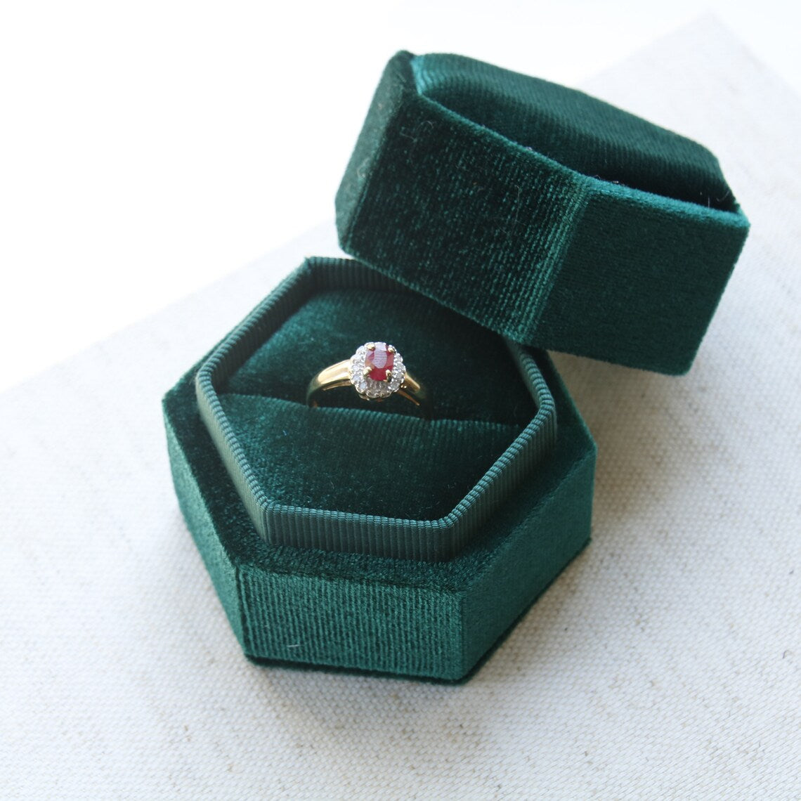 Secondhand Vintage Garnet and Ring. Halo cut Garnet with a halo of diamonds, set in 9ct gold.