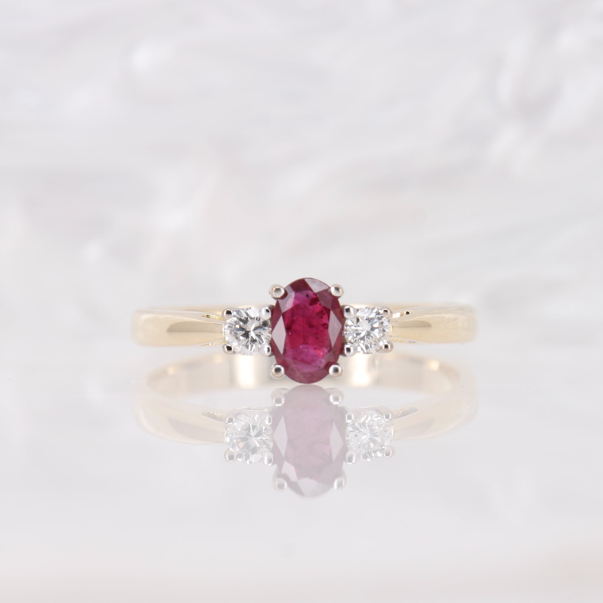 Oval cut Ruby and Diamond Trilogy Three Stone Engagement Ring