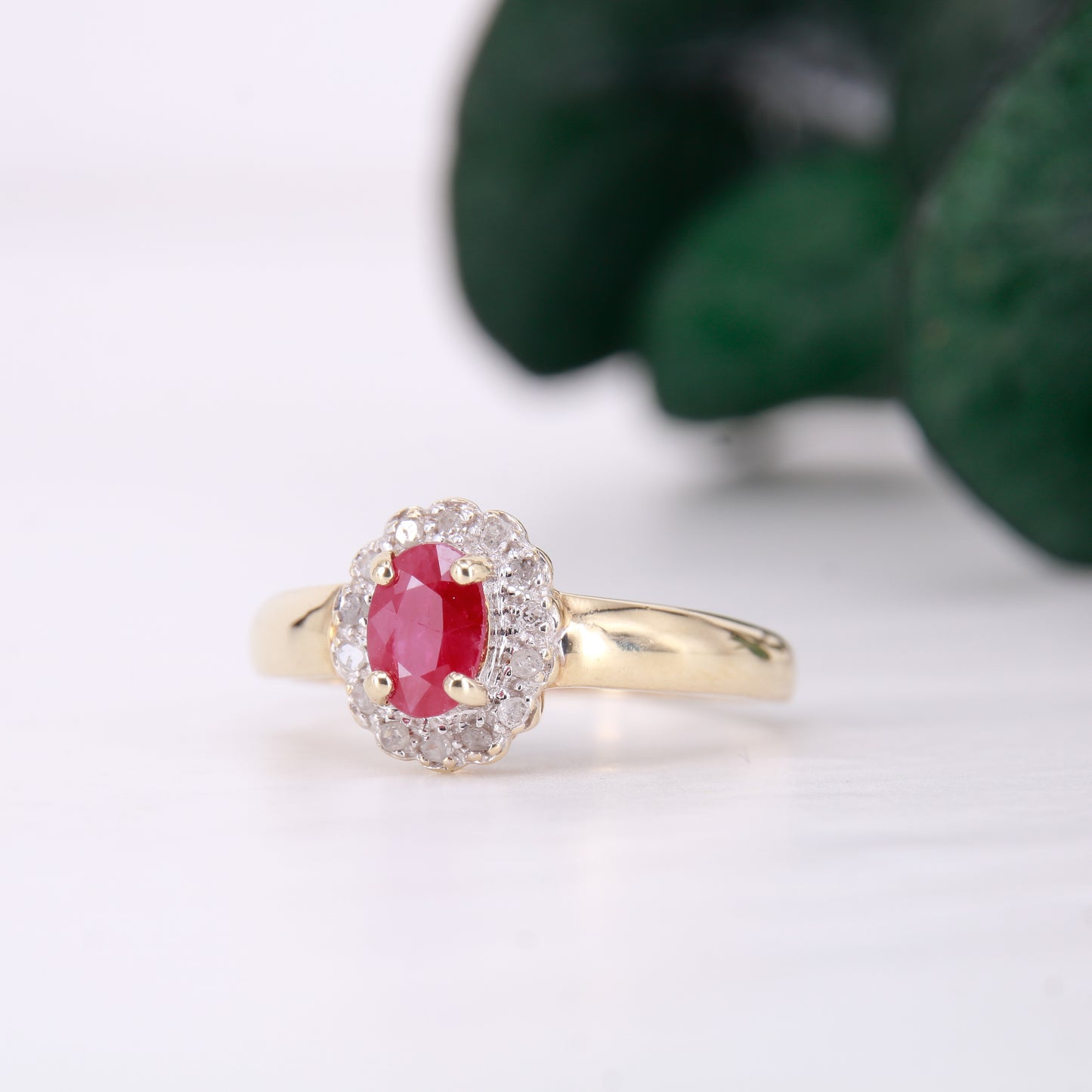 Secondhand Vintage Garnet and Ring. Halo cut Garnet with a halo of diamonds, set in 9ct gold.