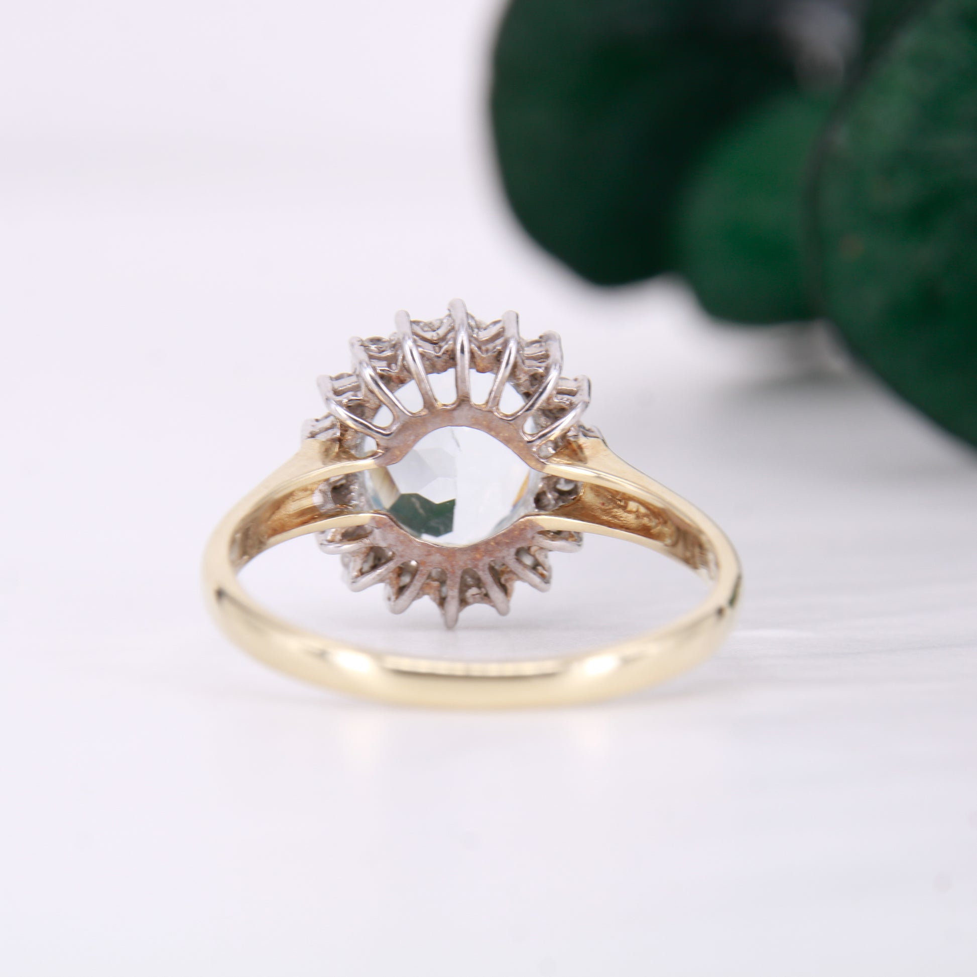 Preowned Aquamarine and Diamond Preowned Ring. Oval cut Aquamarine with a halo of diamonds set in 9ct yellow gold. 