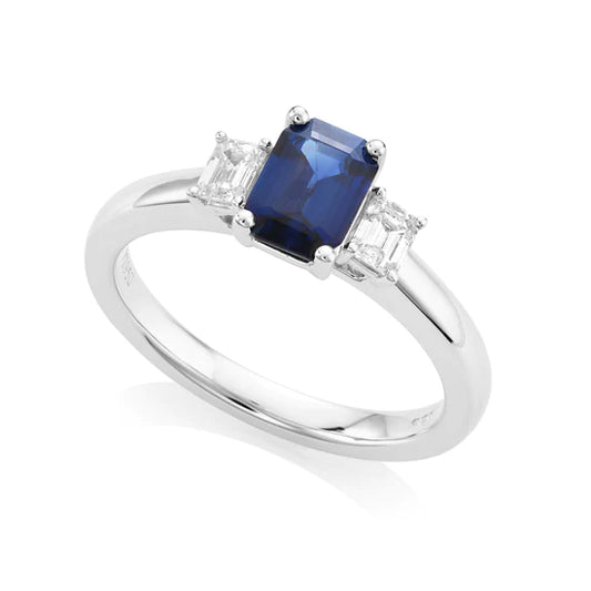 Emerald cut sapphire and diamond ring set in platinum. 